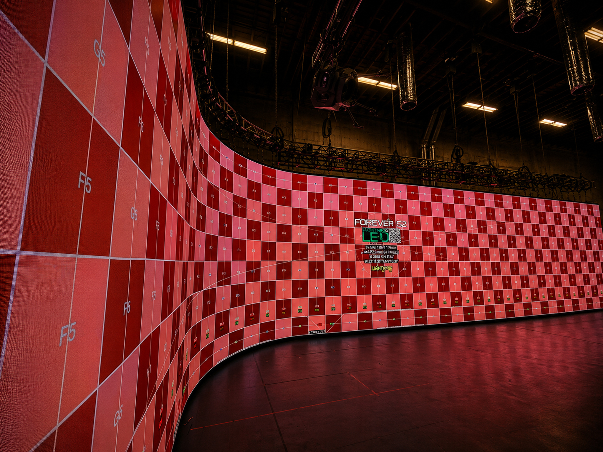 Curved red LED wall with calibration grid and lift equipment.